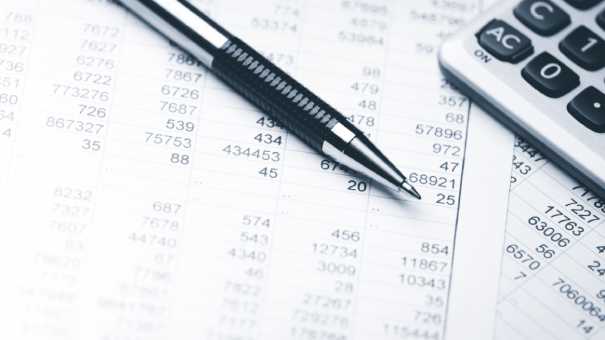 Pen and calculator on top of statements